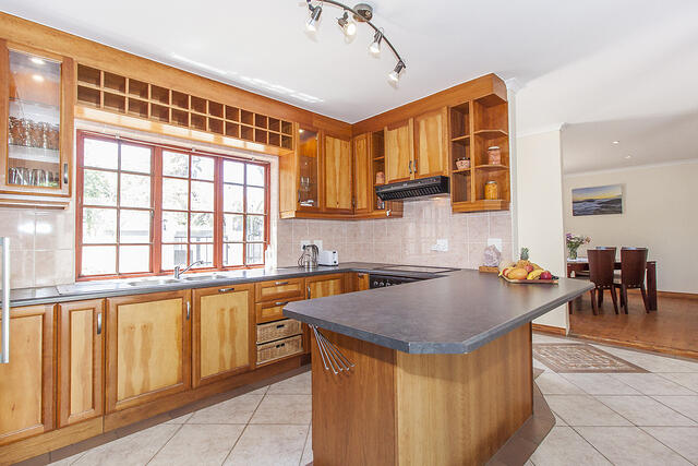 Kitchen facing stove and dinning room